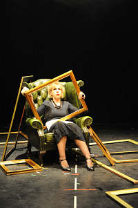 Woman in chair with frame on her lap
