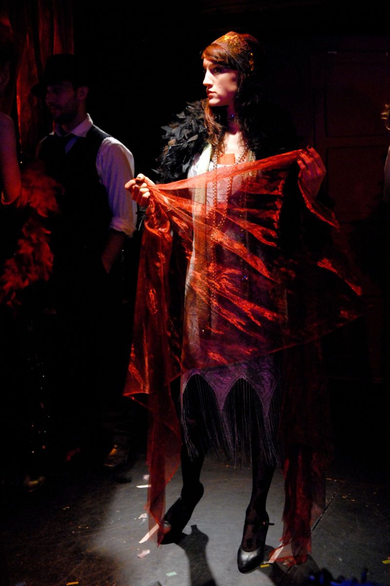 A club girl is waiting to start her performance in a speakeasy.