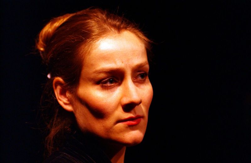 Head shot of a woman (Amelia) without a necklace. Her facial exprssion is composed and contemplative.