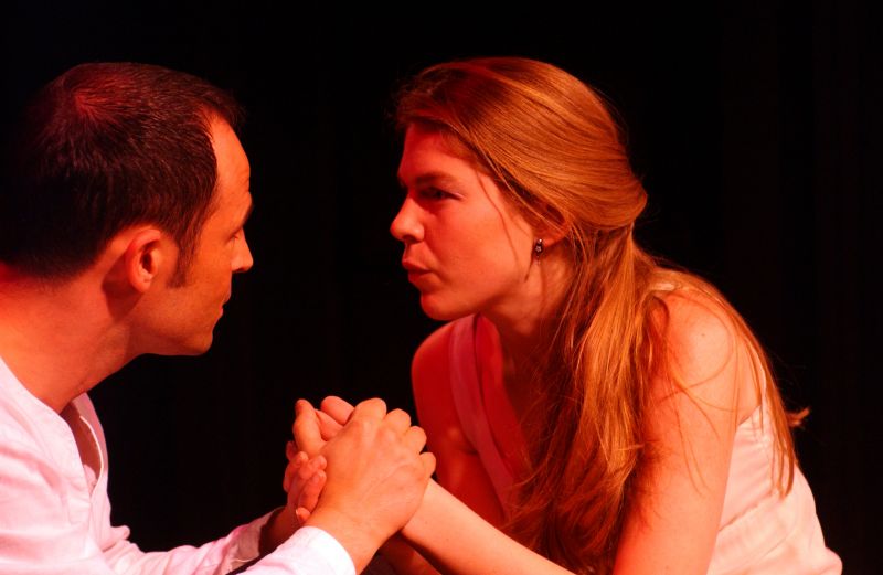 Miss Julie and Jean are clutching each other&#039;s hands. Jean facial expression is suggesting a promise. Miss Julie&#039;s facial expression is suggesting a level of readiness.